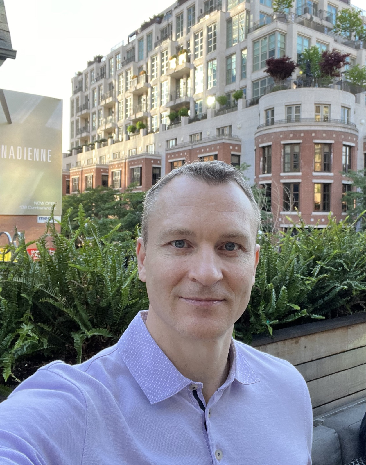 Vlad Lia outdoors in a light collared shirt